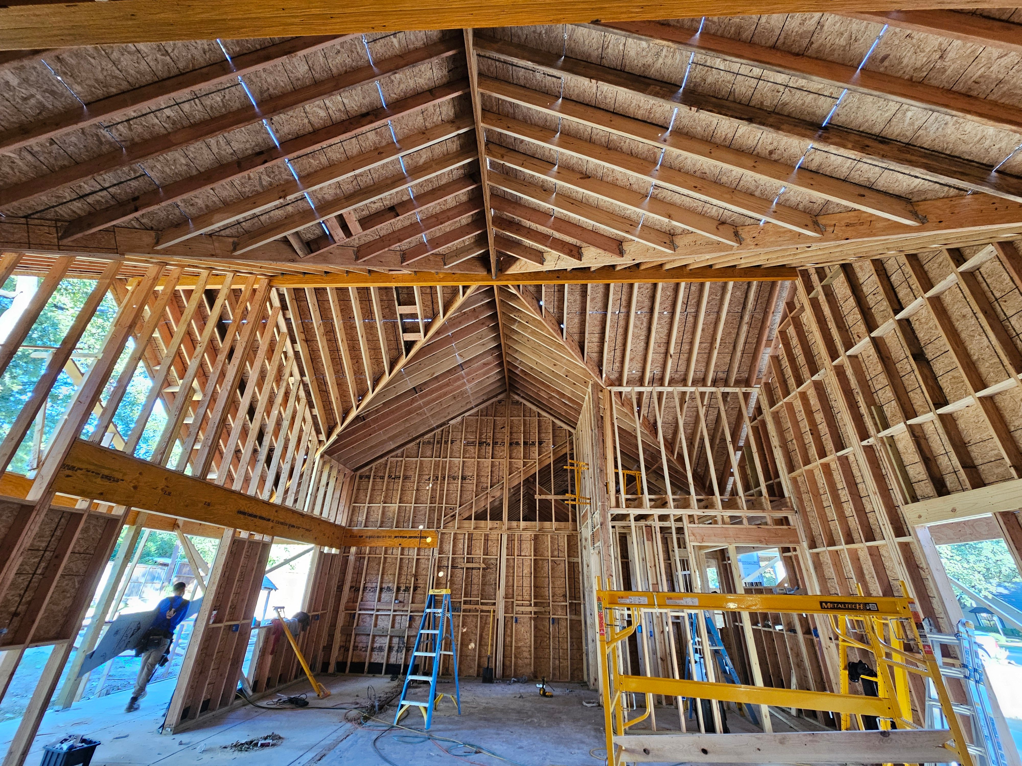 Architectural interior framing with exposed timber beams and strong geometry by Nova Luxe Homes