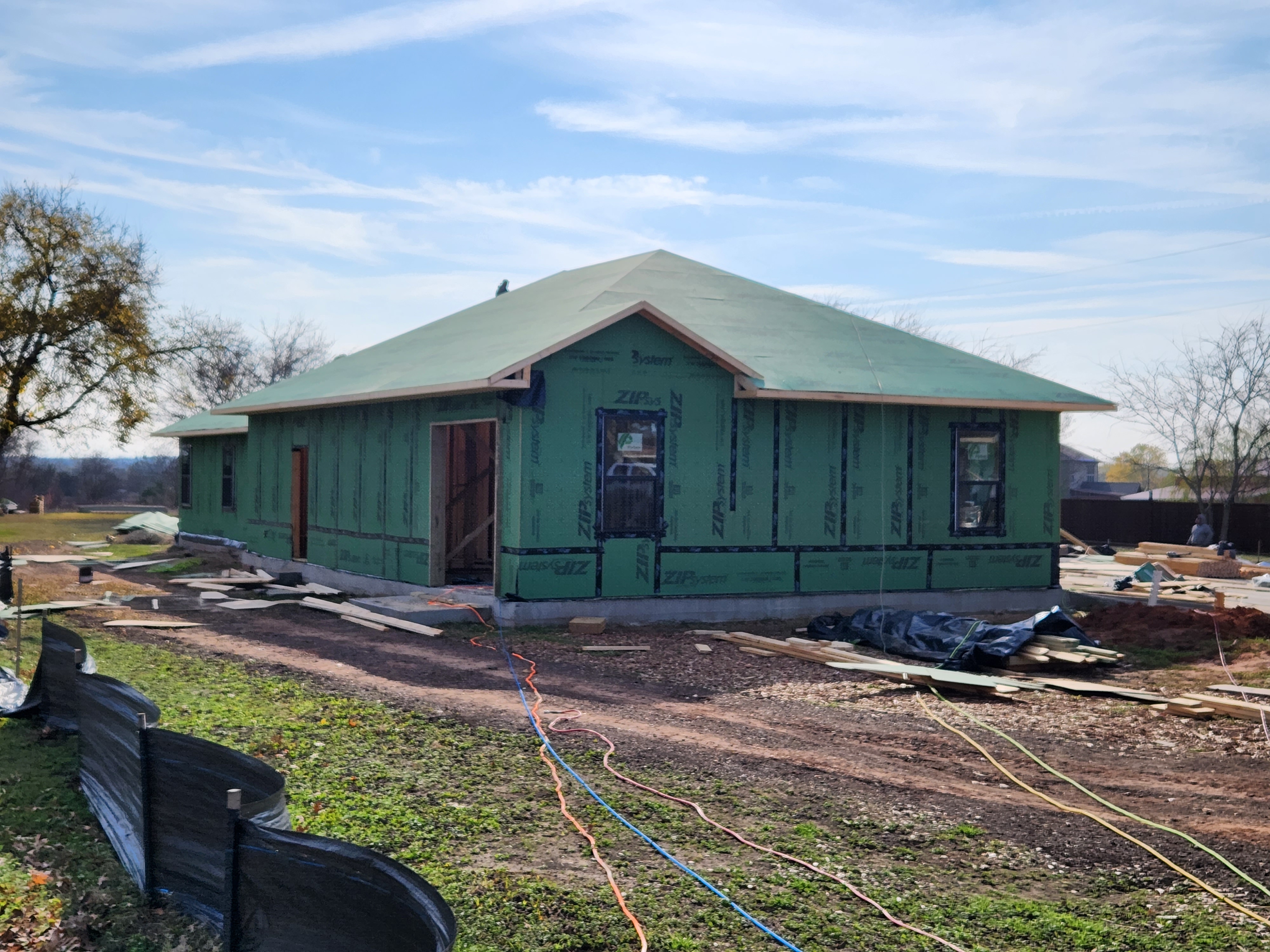 Project manager reviewing plans with a crew on site