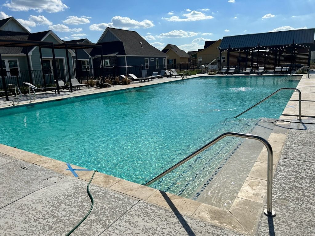 Commercial amenity space with pool deck and shade structure